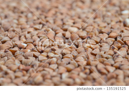 Industrial style image of buckwheat kernels, Detailed macro photography showcasing uniformity and structural features of buckwheat kernels for packaging and market display 135191525