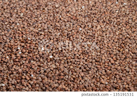 Detailed macro image showcasing buckwheat kernels and lighting effects, Sharp macro photograph emphasizing texture and subtle variations of buckwheat organic grains Detailed macro image showcasing buckwheat kernels and lighting effects, Sharp macro photograph emphasizing texture and subtle variations of buckwheat organic grains 135191531