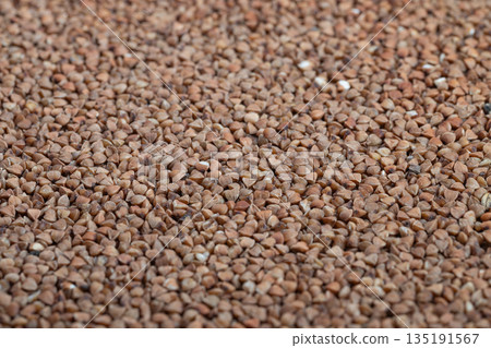Warm toned flat buckwheat pattern design, Detailed image of buckwheat groats with consistent pattern and natural warm tones suitable for product labels and banners 135191567