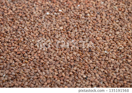 Closeup of healthy buckwheat, Detailed view emphasizing fiber and wholesome meal preparation, Vivid closeup capturing individual buckwheat kernels and natural meal appeal 135191568