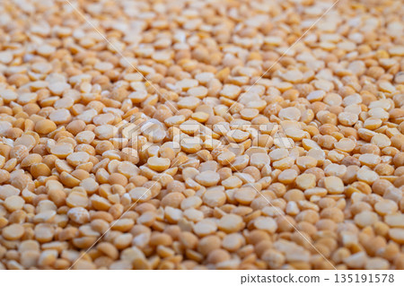 Split peas texture, Organic split peas for nourishing vegan dishes and soups, Natural textured legumes with warm colors ideal for healthy plantbased recipes and meal preparation 135191578