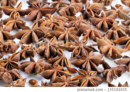 Closeup of aromatic anise for baking purposes, Detailed macro shot of anise pods with holiday ambiance, Arranged anise seeds and pod sections creating cozy baking holiday scene 135191635
