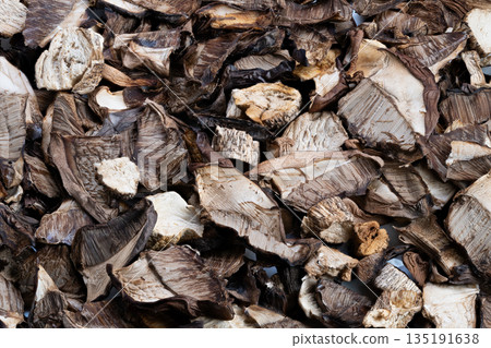 Highresolution image showcasing textured organic mushroom surface detail, Closeup macro photograph capturing intricate textured pattern of dried earthy mushrooms for design use 135191638