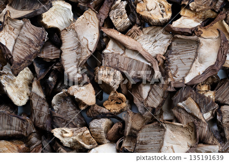 Closeup dried porcini mushroom slices concentrated umami flavor, gourmet kitchen ingredient, ideal for risotto, broth infusion, intense aroma, cheffocused inspiration Closeup dried porcini mushroom slices concentrated umami flavor, gourmet kitchen ingredient, ideal for risotto, broth infusion, intense aroma, cheffocused inspiration 135191639