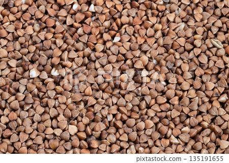 Buckwheat kernels showcase, Rustic dry husks highlight textures, Artisanstyle imagery captured with warm tones, Closeup of buckwheat showing detailed husks and coarse texture Buckwheat kernels showcase, Rustic dry husks highlight textures, Artisanstyle imagery captured with warm tones, Closeup of buckwheat showing detailed husks and coarse texture 135191655
