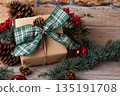 Christmas present box with green bow and natural fir branch on rustic wooden background Christmas present box with green bow and natural fir branch on rustic wooden background 135191708