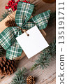 Christmas square gift tag mockup with present box on rustic background Christmas square gift tag mockup with present box on rustic background 135191711