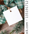 Christmas square gift tag mockup with present box on rustic background Christmas square gift tag mockup with present box on rustic background 135191712