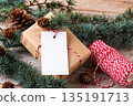 Christmas rectangle gift tag mockup with present box on rustic wooden background Christmas rectangle gift tag mockup with present box on rustic wooden background 135191713