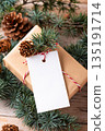 Christmas rectangle gift tag mockup with present box and fir branch Christmas rectangle gift tag mockup with present box and fir branch 135191714