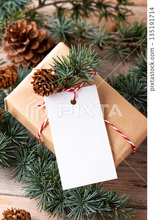 Christmas rectangle gift tag mockup with present box and fir branch Christmas rectangle gift tag mockup with present box and fir branch 135191714