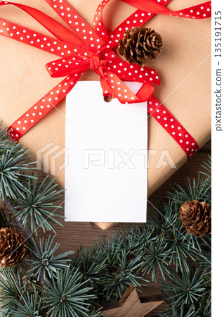 Christmas rectangle gift tag mockup with present box top view Christmas rectangle gift tag mockup with present box top view 135191715