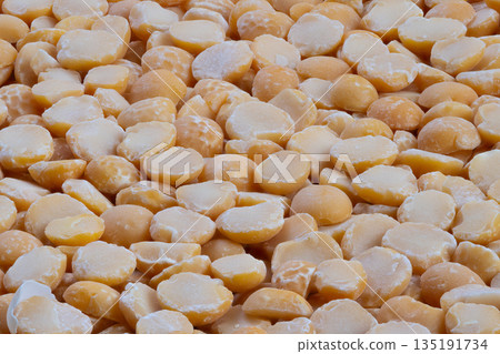 Close up yellow split peas ready for vegan stew preparation, high protein plant ingredient with textured edges and warm tones, ideal for nutrition visuals and recipe content Close up yellow split peas ready for vegan stew preparation, high protein plant ingredient with textured edges and warm tones, ideal for nutrition visuals and recipe content 135191734