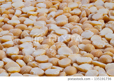 Golden yellow pea pattern, Detailed image of yellow split peas with textured surface, Natural yellow pea texture highlighting dense layered pattern suitable for packaging 135191736