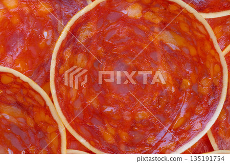Grocery chorizo closeup for label photography, cured sausage slices showing marbling and color fidelity suited for retail packaging and online product catalogues Grocery chorizo closeup for label photography, cured sausage slices showing marbling and color fidelity suited for retail packaging and online product catalogues 135191754