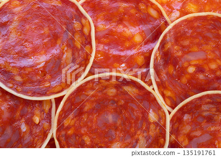 Slices of chorizo prepared with cheese and spices for cooking, Thin slices of cured chorizo arranged deliciously for oven baking with cheese and aromatic seasonings Slices of chorizo prepared with cheese and spices for cooking, Thin slices of cured chorizo arranged deliciously for oven baking with cheese and aromatic seasonings 135191761