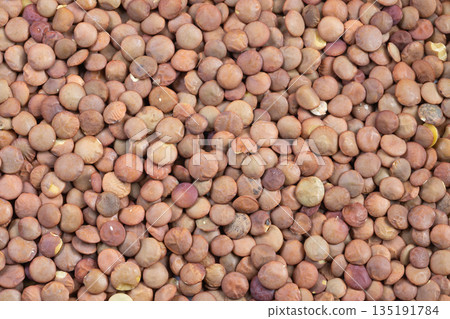 Closeup of lentil component ready for meal preparation in warm kitchen ambiance, Detailed view of plantderived lentil element prepared for culinary use in cozy kitchen setting Closeup of lentil component ready for meal preparation in warm kitchen ambiance, Detailed view of plantderived lentil element prepared for culinary use in cozy kitchen setting 135191784