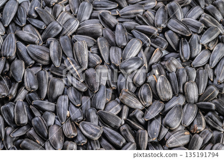 Macro glossy roasted kernels with sheen, tight focus on shine and seasoning granules creating premium gourmet mood, ideal for advertising, packaging, recipe content 135191794
