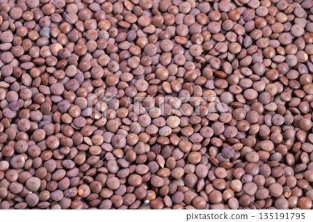 Decorative lentil arrangement emphasizing texture and appearance for advertising, Stylistic decoration of lentils focused on showcasing their attributes for promotional purposes Decorative lentil arrangement emphasizing texture and appearance for advertising, Stylistic decoration of lentils focused on showcasing their attributes for promotional purposes 135191795