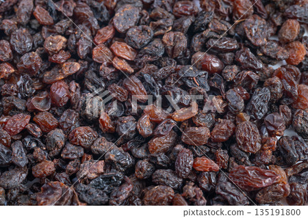 Basket of Wrinkled Brown Raisins with Sugar Crystals, Detailed Closeup of Piled Dark Raisins Enhanced by Glossy Surface and Subtle Sugar Crystals for Culinary Photography 135191800
