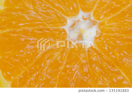 Bold orange texture in abstract macro composition with radial segments and glossy highlights, artistic approach ideal for backgrounds, textiles, and creative marketing projects 135191883