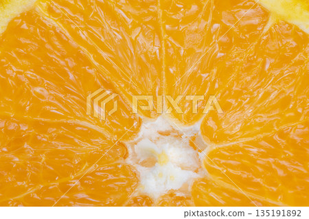 Juicy citrus closeup, Bright slice of fresh citrus, Detailed macro image of vibrant orange piece, Highresolution photograph capturing juicy orange with zest and pulp 135191892