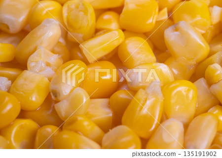 Bright yellow sweet corn pieces, Closeup of juicy yellow corn kernels for salads, Closeup image showcasing lively yellow corn kernels ideal for healthy and vegan recipes 135191902