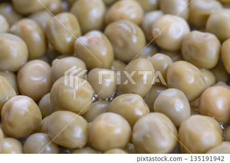 Shiny pea closeup, Glossy canned peas for recipes, Closeup shot of shiny peas in light brine, Highquality macro image showcasing glossy canned peas with subtle reflections Shiny pea closeup, Glossy canned peas for recipes, Closeup shot of shiny peas in light brine, Highquality macro image showcasing glossy canned peas with subtle reflections 135191942