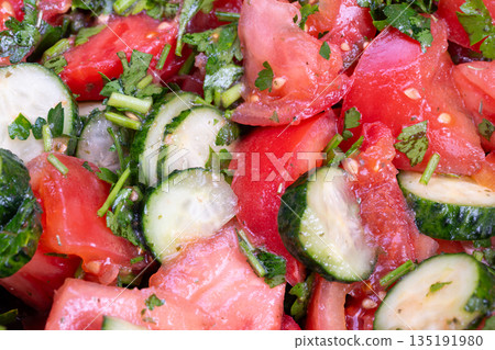 Mediterranean inspired tomato cucumber herb salad using sunflower oil alternative, chopped mint and parsley, zesty lemon notes, fresh garden produce, colorful plated side 135191980