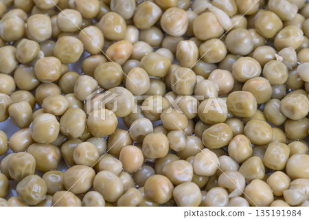 Vintage style canned green peas, Glistening peas preserved in salty liquid, Detailed shot capturing moist peas in salty solution reminiscent of nostalgic comfort foods Vintage style canned green peas, Glistening peas preserved in salty liquid, Detailed shot capturing moist peas in salty solution reminiscent of nostalgic comfort foods 135191984