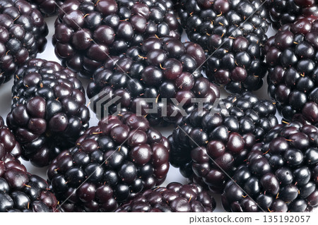 Exquisite presentation of glossy ripe berries under perfect lighting, Detailed view capturing vibrant sheen and freshness of luscious berries for culinary presentation Exquisite presentation of glossy ripe berries under perfect lighting, Detailed view capturing vibrant sheen and freshness of luscious berries for culinary presentation 135192057