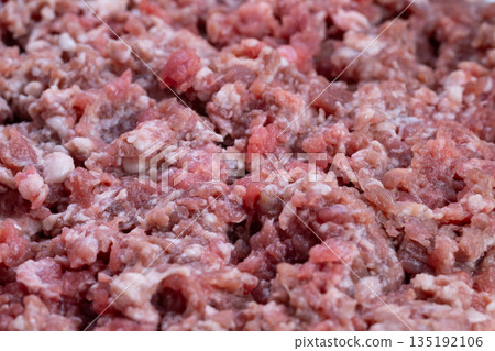 Uncooked chopped meat image emphasizing protein content and energy focus, Detailed view of raw ground meat highlighting nutritional aspects for athletes and fitness enthusiasts Uncooked chopped meat image emphasizing protein content and energy focus, Detailed view of raw ground meat highlighting nutritional aspects for athletes and fitness enthusiasts 135192106