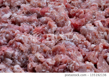Fresh beef closeup, Uncooked chopped beef showing coarse texture perfect for dishes, Detailed view of fresh ground beef with visible coarse texture suitable for recipes 135192136