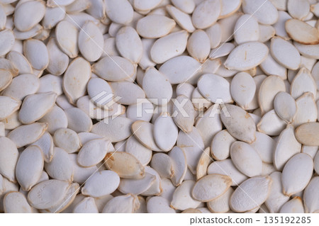 Crispy roasted pumpkin seeds add Mediterranean flavor notes to dishes, Baked pumpkin seeds serve as flavorful crunchy topping and visual appeal for salads and plates 135192285