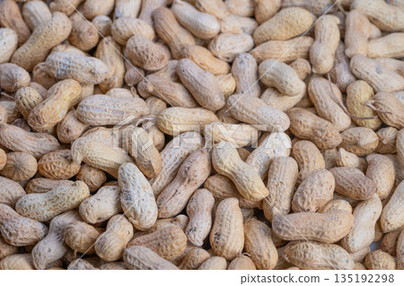 Uniform shelled peanuts captured with high contrast and clarity, Collection of densely packed raw peanuts showcasing texture and consistency for commercial purposes Uniform shelled peanuts captured with high contrast and clarity, Collection of densely packed raw peanuts showcasing texture and consistency for commercial purposes 135192298