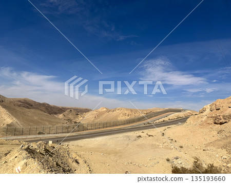 Highway and fence on the border with Egypt in the Eilat Mountains 135193660