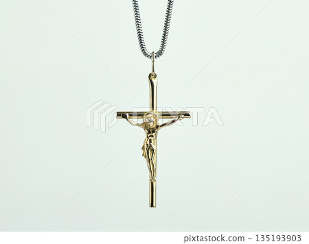 A detailed gold crucifix necklace featuring Jesus Christ on a silver snake chain, white background 135193903