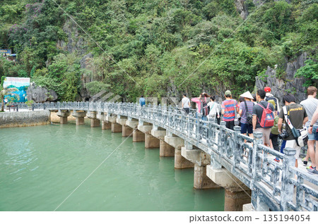 Tourists crossing a bridge over Halong Bay, one of Vietnam's World Heritage Sites 135194054