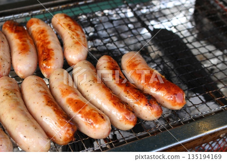 Wiener sausages grilled on a barbecue 135194169