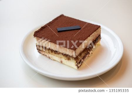 Square Tiramisu served on plate in the cafe Square Tiramisu served on plate in the cafe 135195335
