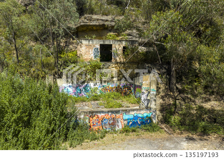Photograph of an old stone mining house covered in graffiti artwork Photograph of an old stone mining house covered in graffiti artwork 135197193