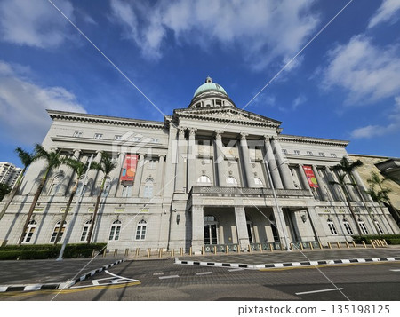 The National Gallery Singapore showcases neoclassical grandeur with Corinthian columns, a central dome, and art banners, blending colonial heritage, culture The National Gallery Singapore showcases neoclassical grandeur with Corinthian columns, a central dome, and art banners, blending colonial heritage, culture 135198125