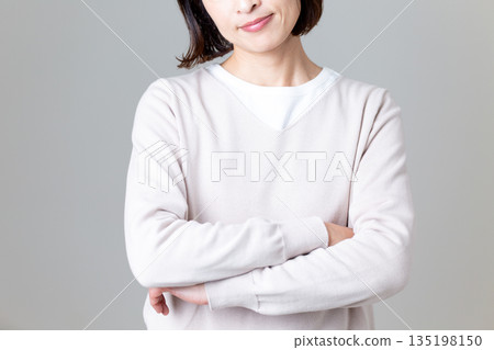 身穿休閒針織衫的中年婦女,神情憂慮 身穿休閒針織衫的中年婦女,神情憂慮 135198150