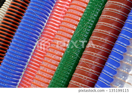 Group of multi-colored corrugated plastic hoses Group of multi-colored corrugated plastic hoses 135199115