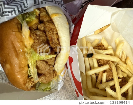 A classic combination of a juicy burger with fresh toppings served alongside golden, crispy French fries. Perfect for a satisfying meal that blends savory flavors and crunchy textures. A classic combination of a juicy burger with fresh toppings served alongside golden, crispy French fries. Perfect for a satisfying meal that blends savory flavors and crunchy textures. 135199414
