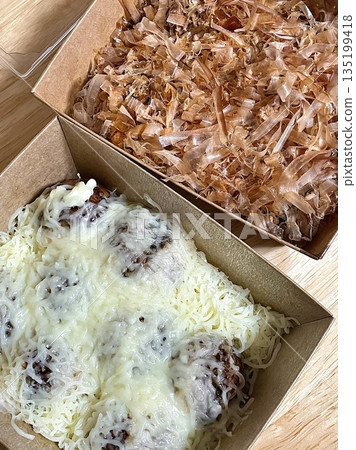 Takoyaki, a popular Japanese street food, are crispy round dough balls filled with octopus, tempura bits, and pickled ginger, topped with takoyaki sauce, bonito flakes, and aonori. Takoyaki, a popular Japanese street food, are crispy round dough balls filled with octopus, tempura bits, and pickled ginger, topped with takoyaki sauce, bonito flakes, and aonori. 135199418