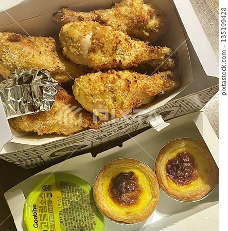 Crispy Korean fried chicken with bold, savory glaze paired with sweet, creamy egg tart, offering a unique and satisfying contrast of flavors and textures in every delicious bite. Crispy Korean fried chicken with bold, savory glaze paired with sweet, creamy egg tart, offering a unique and satisfying contrast of flavors and textures in every delicious bite. 135199428