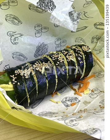 Delicious kimbap rolls filled with fresh vegetables, seasoned rice, and savory proteins, all wrapped in crisp seaweed. A perfect combination of flavor and texture in every bite. 135199439
