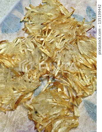 Golden-brown gamja jeon, a classic Korean potato pancake, crispy on the outside and tender inside. Simple yet flavorful, it's a comforting snack or side dish to enjoy anytime. 135199442