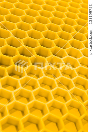 A lot of yellow hexagonal cells, similar to a honeycomb 135199738